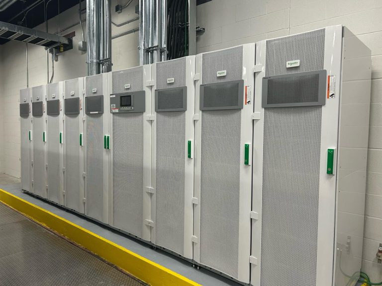 Industrial three-phase UPS system cabinet installed in a data center power room.