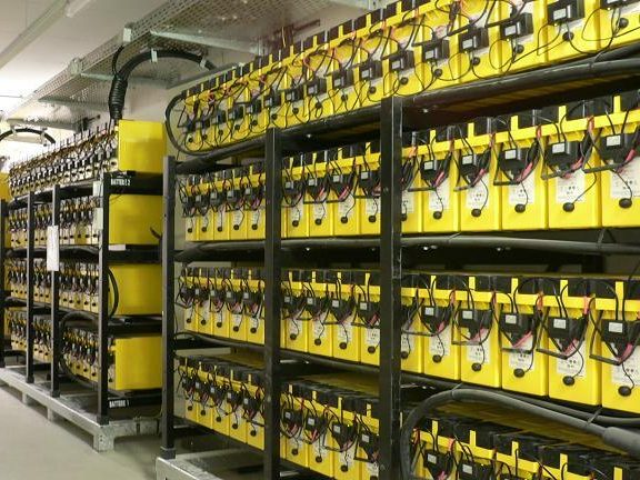 Flooded cell industrial batteries installed in a backup power system rack for telecom or data center application.